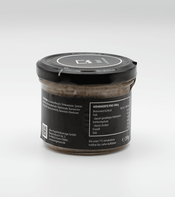 Dunkle Glasdose mit schwarzem Deckel, enthält eine cremige Paste oder Aufstrich, mit Nährwertangaben und Zutaten auf der Rückseite.